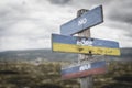 no more war text quote on wooden signpost outdoors on nato colored flag, ukrainian flag and russian flags