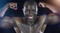 No one can flex like me. Studio shot of a young sportsman flexing his biceps against a dark background.