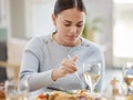 No-one cooks like mom. a young woman enjoying her meal with her family at home. Royalty Free Stock Photo