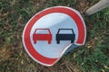 No overtaking traffic sign knocked on the ground Royalty Free Stock Photo