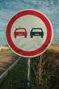 NO OVERTAKING traffic sign perforated by bullet
