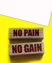 No Pain No Gain message written with wooden blocks on yellow. Business success concept Royalty Free Stock Photo