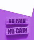 No Pain No Gain message written with wooden blocks on yellow. Business success concept Royalty Free Stock Photo