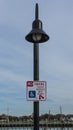 No Parking except for handicapped sign on a lamp post