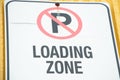 no parking loading zone sign on yellow wall, close up 99 p 20
