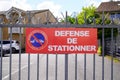 No parking means in french defense de stationner text and sign Do not park in front of residential gate