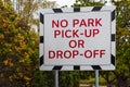 A no parking sign on a board. No park, no pick-up, no drop-off warning on a sign banner