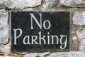 No parking sign on a marble and stone wall Royalty Free Stock Photo