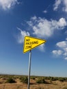 No passing zone sign standing on roadside in a rural area