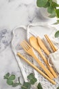 No plastic concept. Top view vertical photo of wooden cutlery fork spoon knife chopsticks white string bag steel straw cleaning Royalty Free Stock Photo