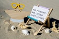 NO POSTING NO LIKING JUST LIVING text on paper greeting card on background of beach chair lounge starfish summer Royalty Free Stock Photo