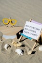 NO POSTING NO LIKING JUST LIVING text on paper greeting card on background of beach chair lounge starfish summer Royalty Free Stock Photo