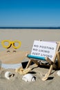 NO POSTING NO LIKING JUST LIVING text on paper greeting card on background of beach chair lounge starfish summer Royalty Free Stock Photo
