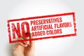 NO PRESERVATIVES ARTIFICIAL FLAVORS ADDED COLORS stamp written in distressed bold text held by a hand with a marker, emphasizing Royalty Free Stock Photo