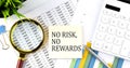 NO RISK NO REWARDS text on sticker on diagram with magnifier and calculator. Business concept Royalty Free Stock Photo