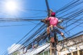 No safety worker technician installing Internet cables on the electricity poles Royalty Free Stock Photo