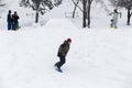 Kid jumping over a hill made of snow with snowboard Royalty Free Stock Photo