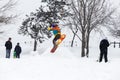 Kid jumping over a hill made of snow with snowboard Royalty Free Stock Photo