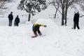 Kid jumping over a hill made of snow with snowboard Royalty Free Stock Photo