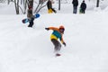 Kid jumping over a hill made of snow with snowboard Royalty Free Stock Photo