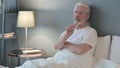 No sign by old man sitting in bed, disapprove