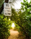 No Skinny Dipping Alone sign at the beach pathway