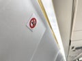 No smoking allowed sign inside an airplane