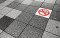 No smoking area warning on pavement.