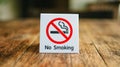 No Smoking label in the public. No smoking sign on wood table at hotel Royalty Free Stock Photo