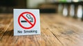 No Smoking label in the public. No smoking sign on wood table at hotel Royalty Free Stock Photo