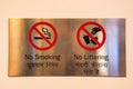 No Smoking and no littering signs on metal plate Royalty Free Stock Photo