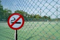 No smoking sign in front of blurred tennis court background Royalty Free Stock Photo