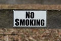 No Smoking sign on rustic fence post for information permitting smoking Royalty Free Stock Photo