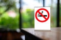 No smoking sign with shopping place background on wooden table Royalty Free Stock Photo