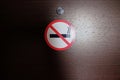 No smoking sign stuck on the wooden door of the hotel room. The crossed out cigarette. Concept signs, rules of conduct in public Royalty Free Stock Photo