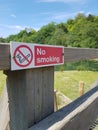 No smoking sign on wood fencing.