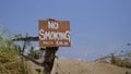 No smoking warning sign on a fence