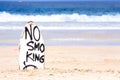 No Smoking warning sign on white surfboard at the beach in summer, concept of sea environmantal protection design, copy space, Royalty Free Stock Photo