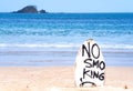 No Smoking warning sign on white surfboard at the beach in summer, concept of sea environmantal protection design, copy space,