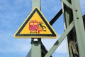 `No stepping over red line` yellow triangular warning signn at German train station showing stylized person falling off platform