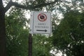 No stop sign says a bus stop in French with a blurry background of tree branches and leaves