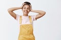 No stress, time for relaxation. Portrait of carefree good-looking happy African American girl in yellow stylish overalls