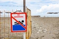 No swim sign on the fence in front of the beach entrance