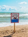 No swimming warning sign on the beach. Inscription in Russian