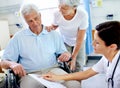 No really thats a good thing. a senior couple getting good news from their doctor. Royalty Free Stock Photo