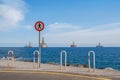 No trespass sign at end of road with ocean background,