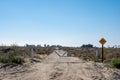 No Trespassing and loitering sign and gate on a dirt desert road, near the Salton Sea of California