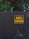 no trespassing warning sign on chain link wire fence Royalty Free Stock Photo