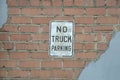 No truck parking, road sign on a brick