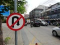 The No U-turn sign is on the sidewalk.